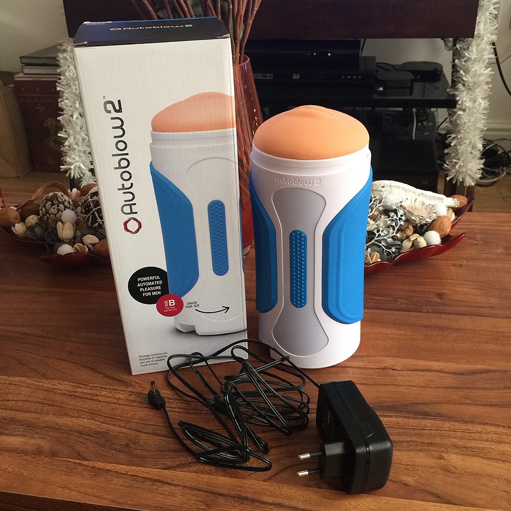 Inside the box is the Autoblow 2, a sleeve, the power cable and a plastic r...